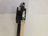 a wooden stick that is attached to a piece of wood