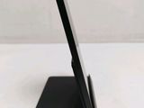 the tablet is sitting on top of the stand on the table