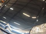 a blue car that is parked in a garage