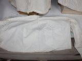 a bed with a white sheet on top of it in a room