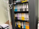 a black cabinet with many files and folders on it