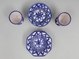a blue and white plate and cups on a table
