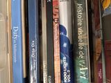 many books in a plastic box on the shelf