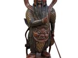 statue of a man with a long beard holding a cane