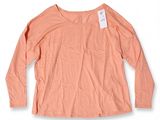 a women ' s long - sleeved t - shirt with a tag on the chest