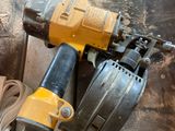 a picture of a corded nailer and a corded nailer on a piece of wood