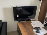 a desk with a computer and a chair in a room