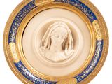 an image of a gold and blue plate with a picture of a woman in a veil
