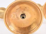 pair of antique brass candlesticks on a white background
