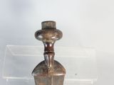 a small wooden figurine in a clear box