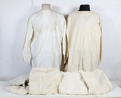 two mannequins are sitting on top of a white table