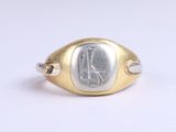 an image of a gold and silver signet ring with the letter k on it