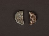 a close up of two pieces of metal on a black surface