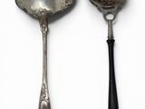 two spoons and a spoon on a white surface