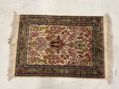 an old rug with a bird on it is laying on the floor