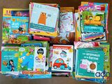 many children ' s books in a box on the floor