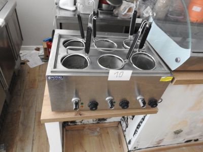 many pots and pans on the counter in this kitchen