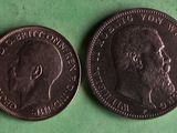 two coins are shown on a green surface, one is a man ' s head and the other is a