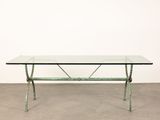 a table with a glass top and metal legs