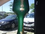 a person holding a green vase with a tree on it