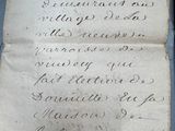 an old piece of paper with writing on it sitting on top of a table