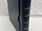 a black book sitting on top of a table next to a white sheet