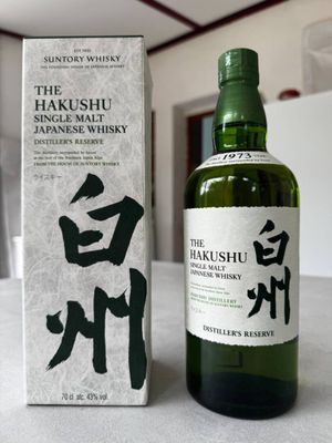 a bottle of hakusushu single malt whisky next to a box