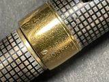 a close up of a fountain pen with a gold cap