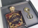 a bottle of liquor and a pair of scissors in a box