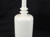 an image of a white bottle with a plastic cap on a black background