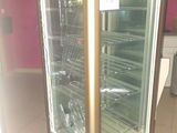 a glass display case in the middle of a room