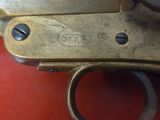 a close up of a gun that is on a red surface
