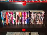a lot of dvd ' s on the shelves in the room