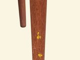a small wooden table with a yellow flower on it