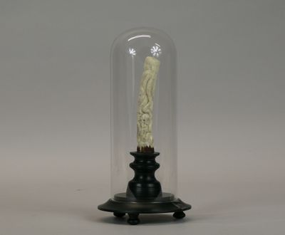 a candle that is in a glass dome on a table