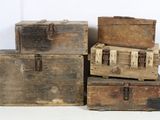 several old wooden trunks stacked on top of each other on a white surface