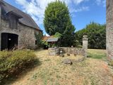 an old stone building sitting next to a lush green field