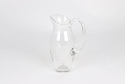 clear glass pitcher with handle on a white background