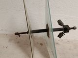 a glass and metal object on a white surface