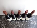 several bottles of wine are lined up in a row on a table