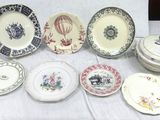many plates and bowls on a table with a white table cloth