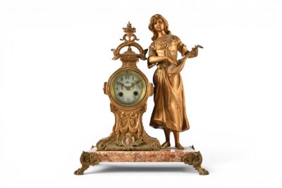 a statue of a woman standing next to a clock