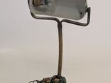 a metal lamp that is on top of a pair of shoes