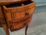 a small wooden table with a drawer on it