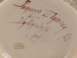 a plate with writing on it sitting on a table