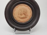 an image of a brown plate with a picture of a woman on it