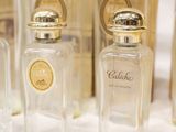 several bottles of perfume are lined up on a table