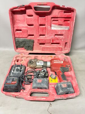 a red tool case with tools in it on a table