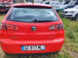 a red car that is parked in the grass