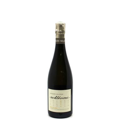 the bottle of wine is sitting on a white surface